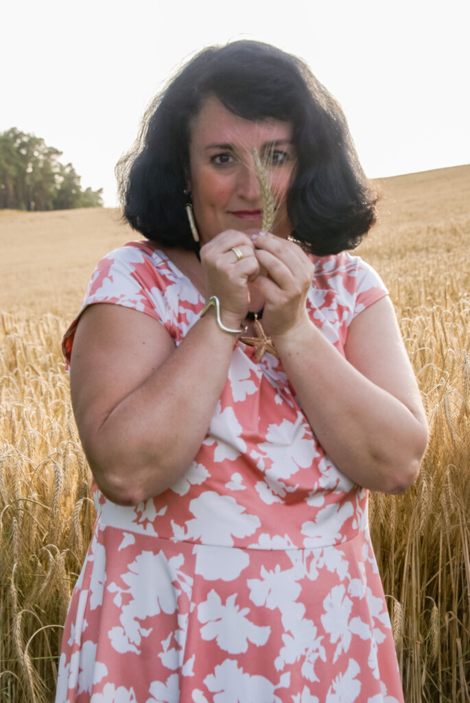 Frau an einem Kornfeld im Hunsrück im Kleid